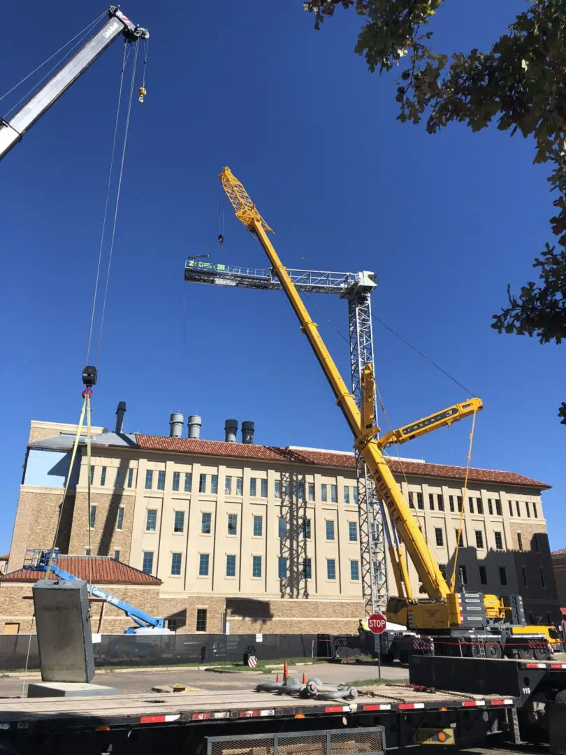 A crane is in front of a building under construction.