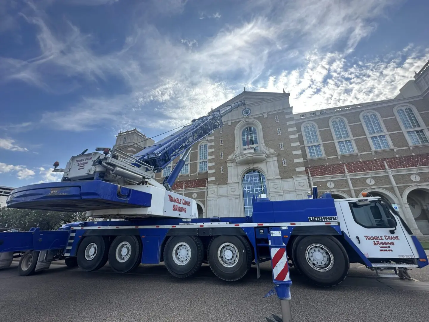 A large crane truck parked in front of a building.