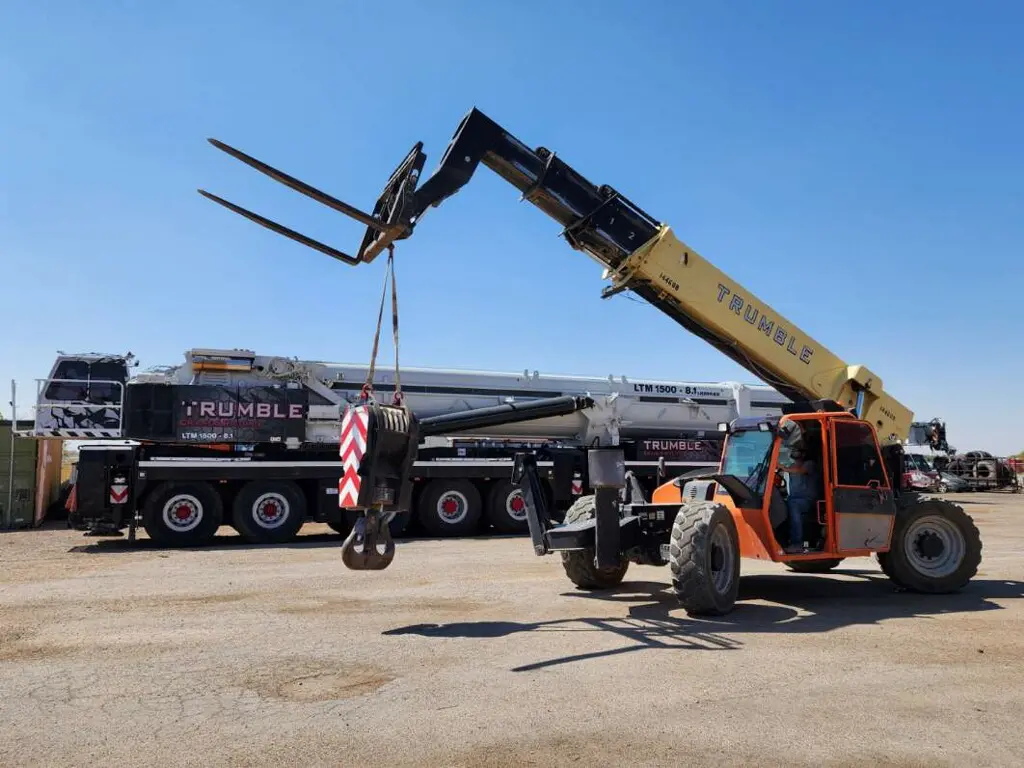 A crane is being used to lift a truck.